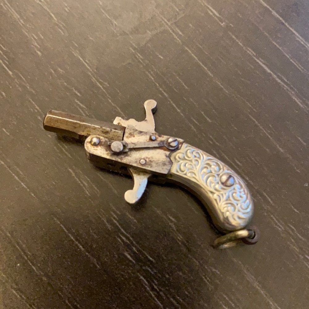 Little metal revolver pendant